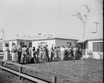 Photograph of people in lineto view a model home, Henderson, 1951