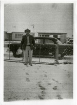 Paul E. Zink standing in front of his house with snow on the ground