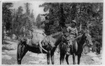 Paul E. Zink on horseback, deer carcass slung over the second horse.